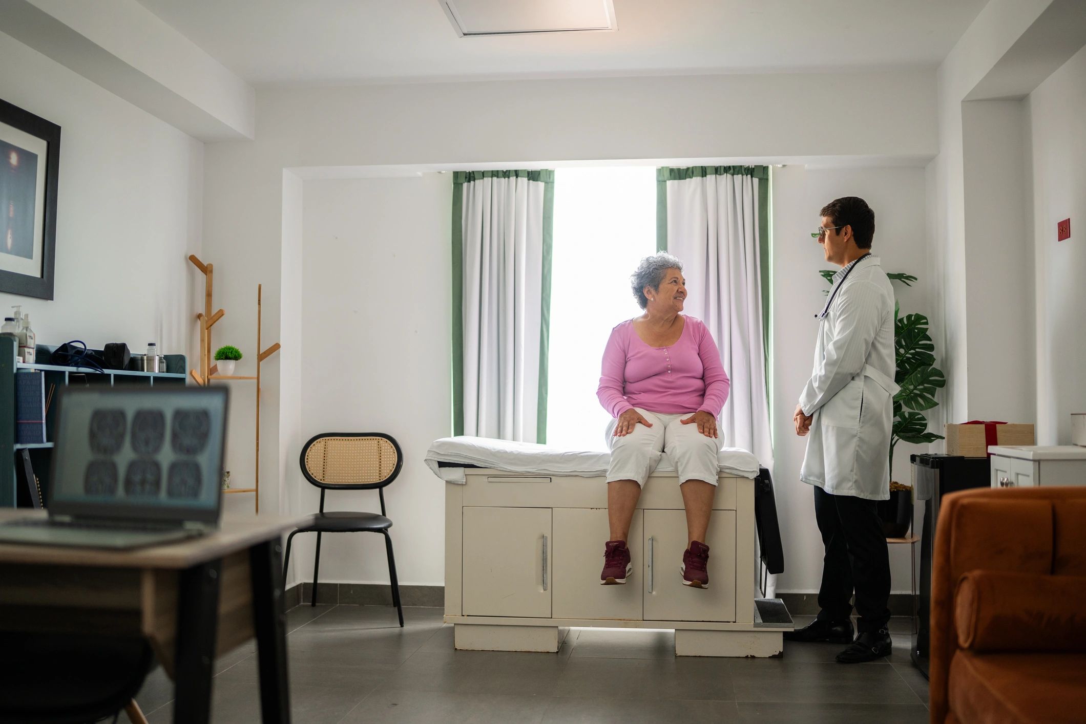 Patient speaking with a doctor in a professional office setting