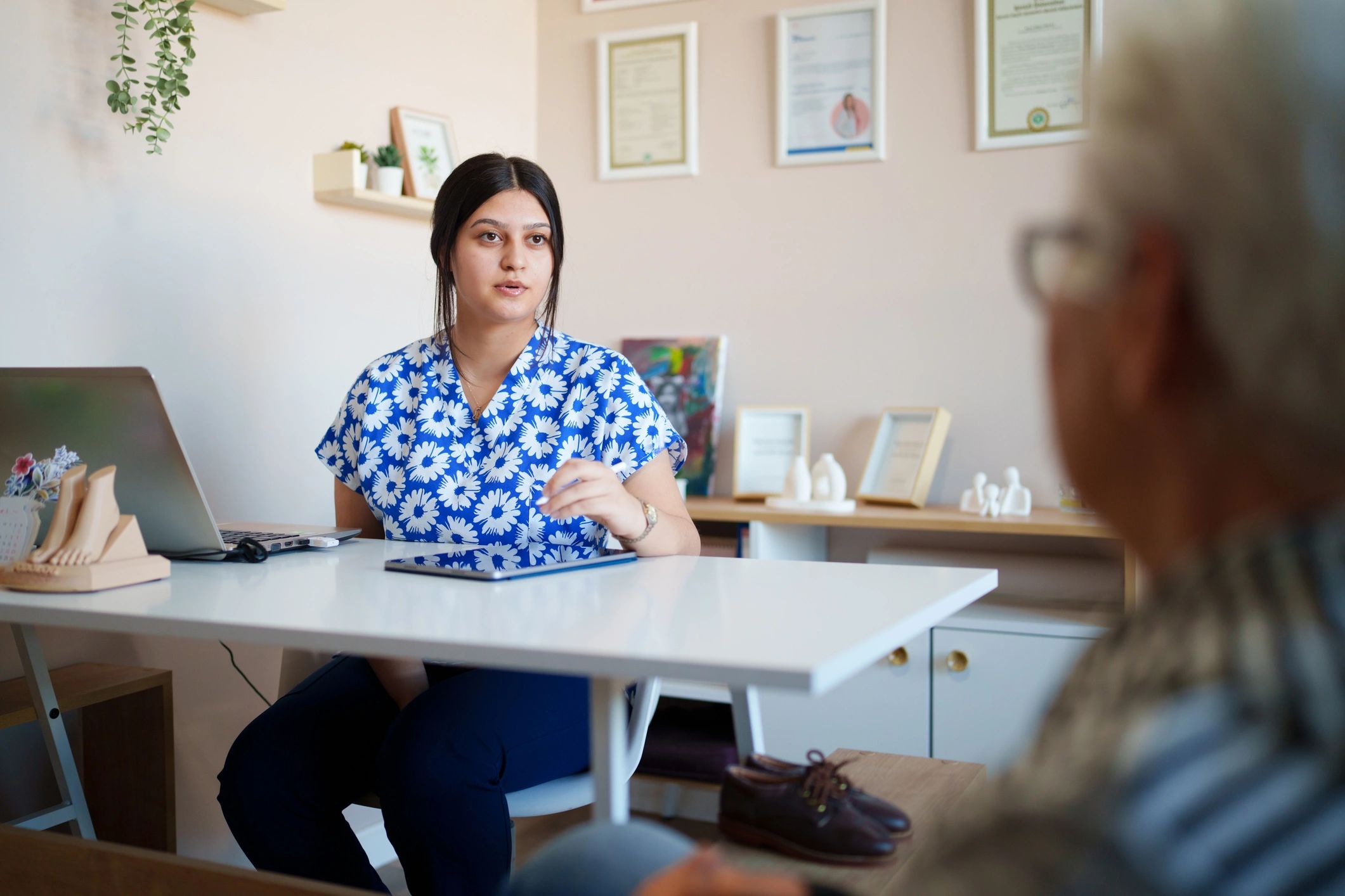 Doctor consulting with a patient using a digital tablet in a modern clinic
